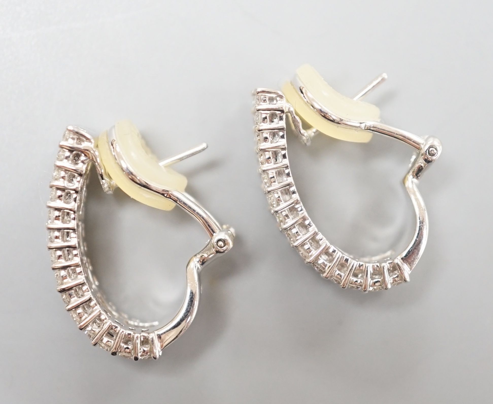 A modern pair of 18k white metal and three row baguette and diamond chip set shaped half hoop earrings, 20mm, gross weight 9.2 grams